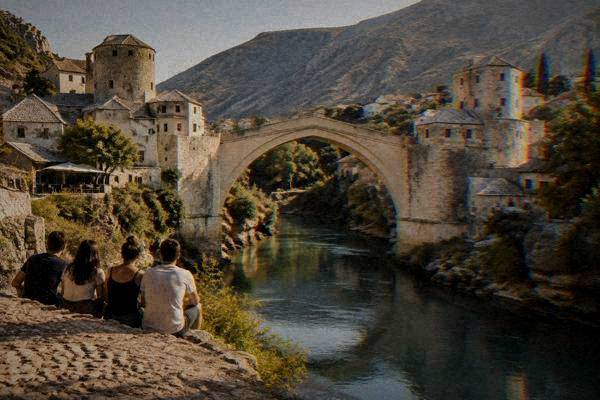 A small group posing with their backs to the camera, Stari Most