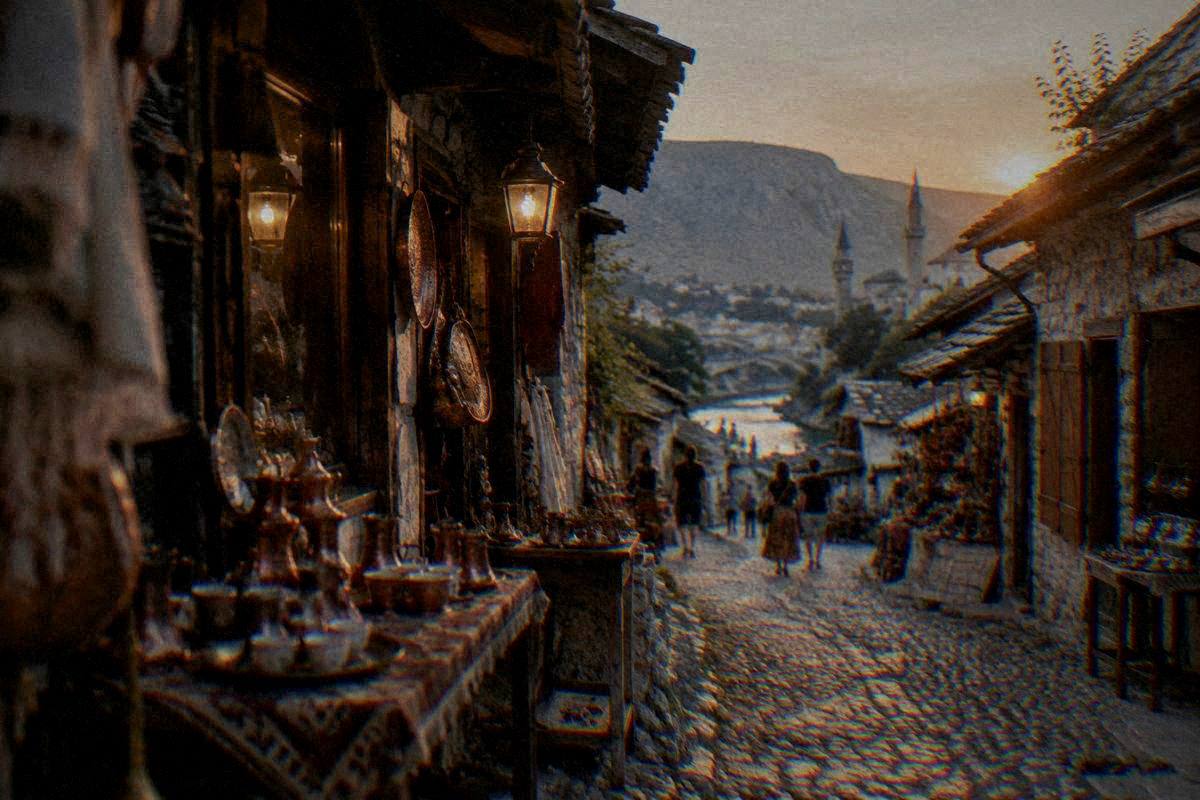 The Kujundziluk bazaar lane in Mostar at dusk, warm lantern light on pebble paving and stone shopfronts, a few distant people