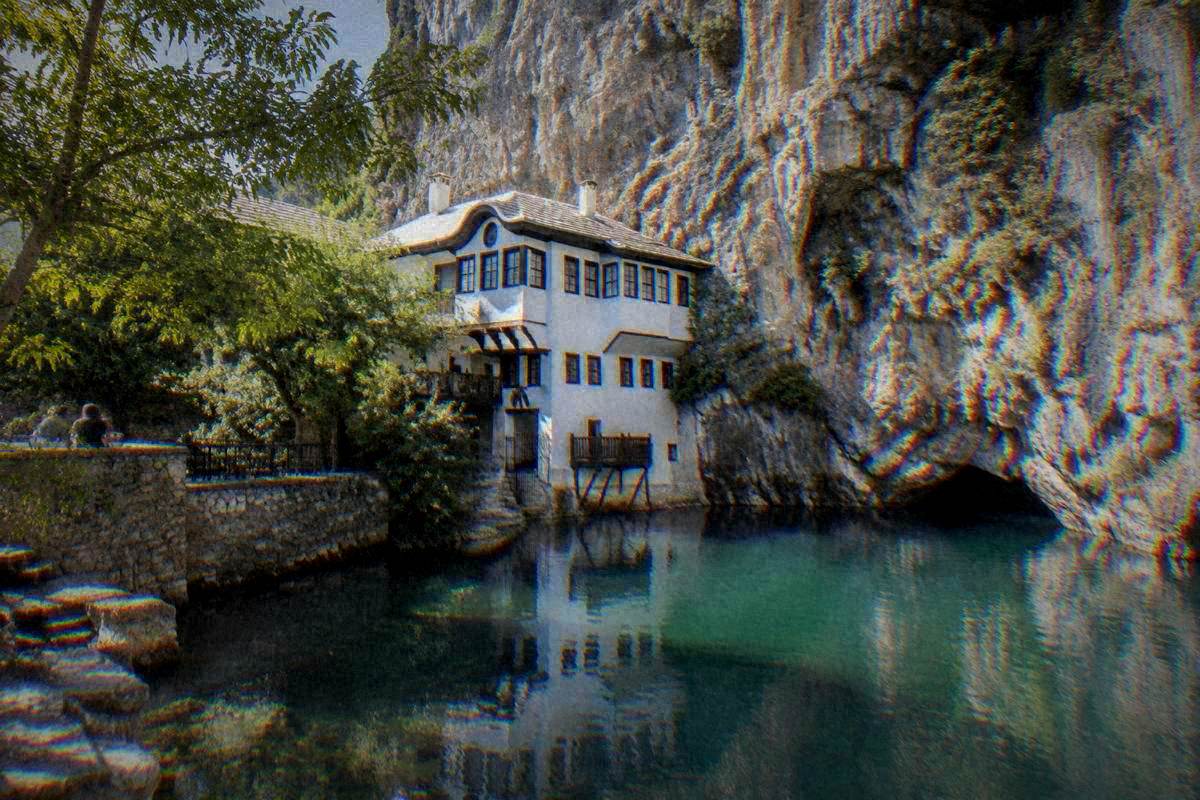 Blagaj Tekke near Mostar, a white-walled dervish house built against a sheer limestone cliff at the source of an emerald river, Blagajska tekija