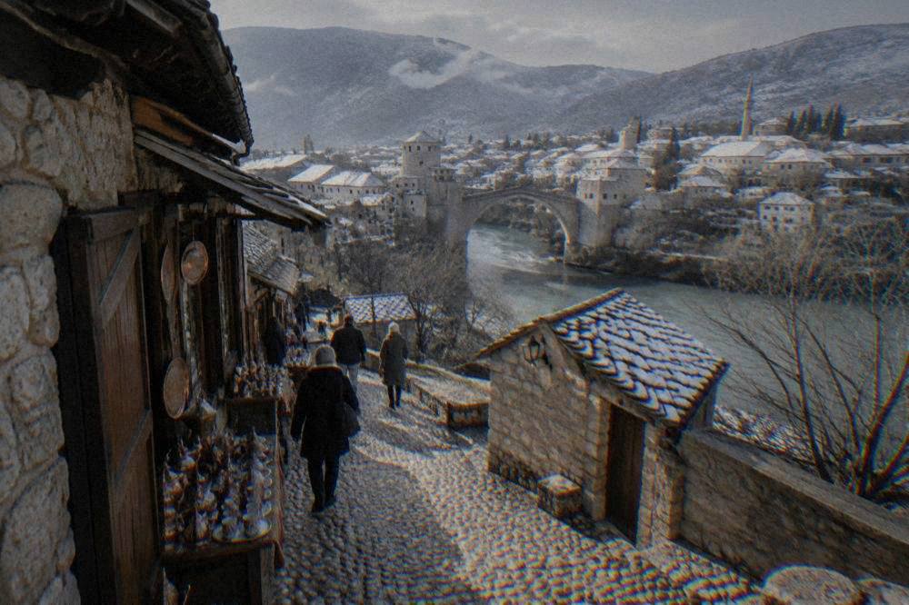 Snow-dusted rooftops of the Old Town in Mostar seen across the Neretva valley