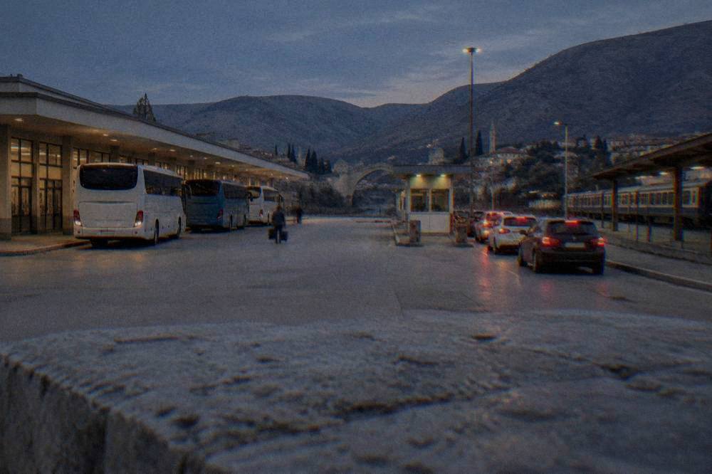 Cars queueing at a small border checkpoint booth between Bosnia and Herzegovina and Croatia