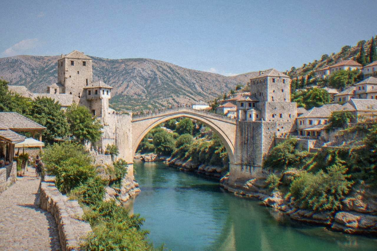 The stone arch of Stari Most spanning the green Neretva river in Mostar