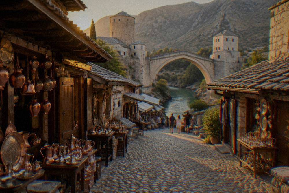 Cobbled bazaar street in Kujundžiluk lined with small copper shops leading toward the Old Bridge