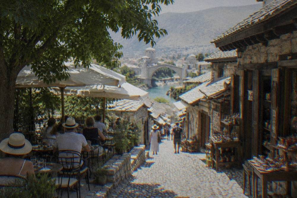 Shaded café tables along the stone street of the old bazaar in Mostar in summer