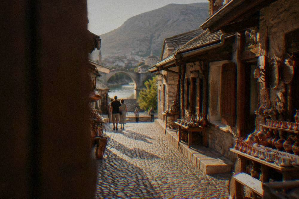 Cobbled lane in the Kujundžiluk bazaar with copper shops and stone buildings