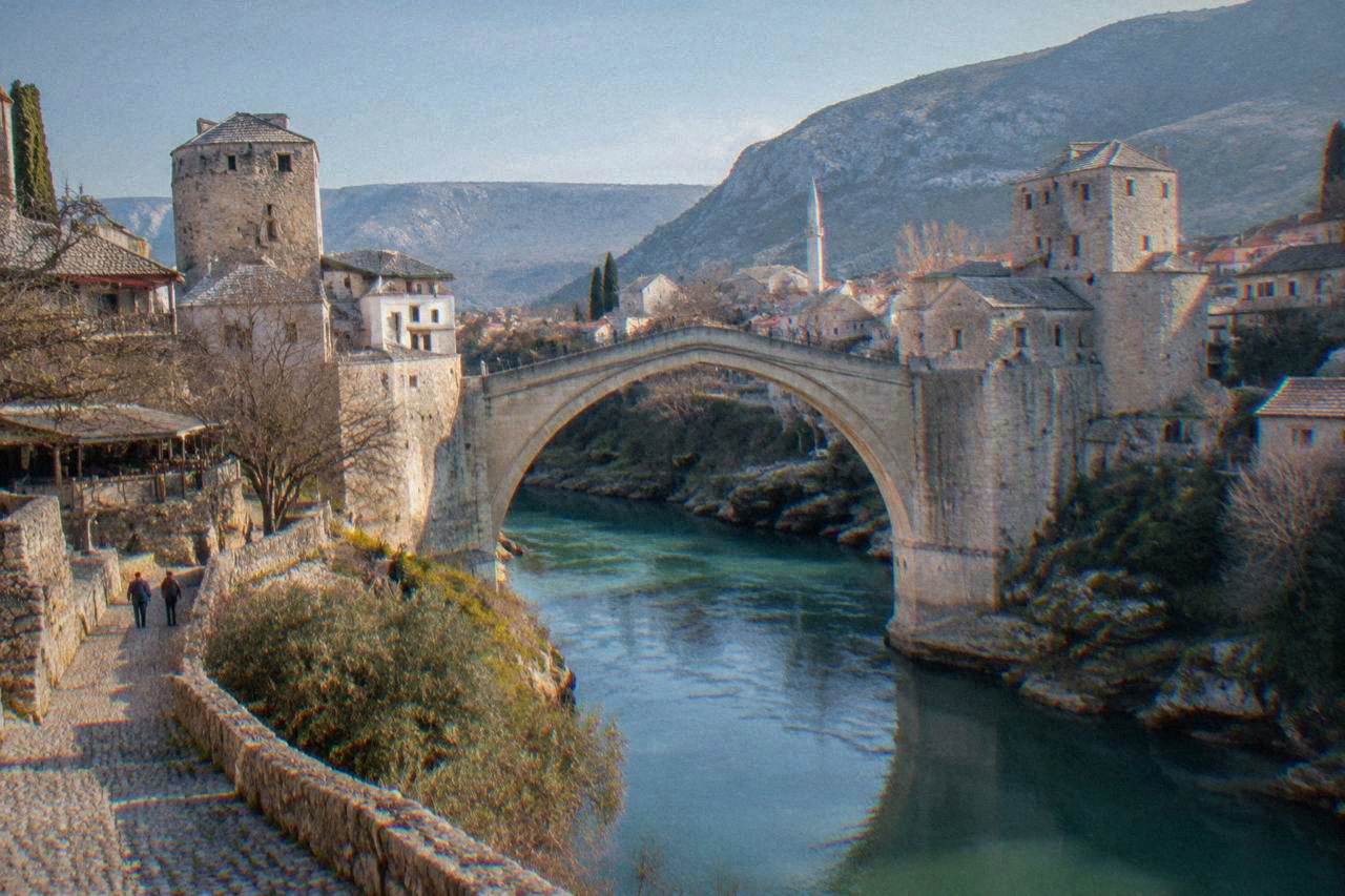The stone arch of Stari Most spanning the green Neretva river in Mostar