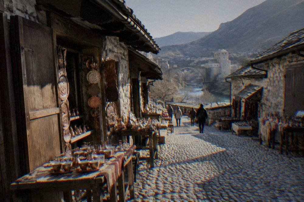A cobbled bazaar street in Mostar lined with stone shops and craft stalls