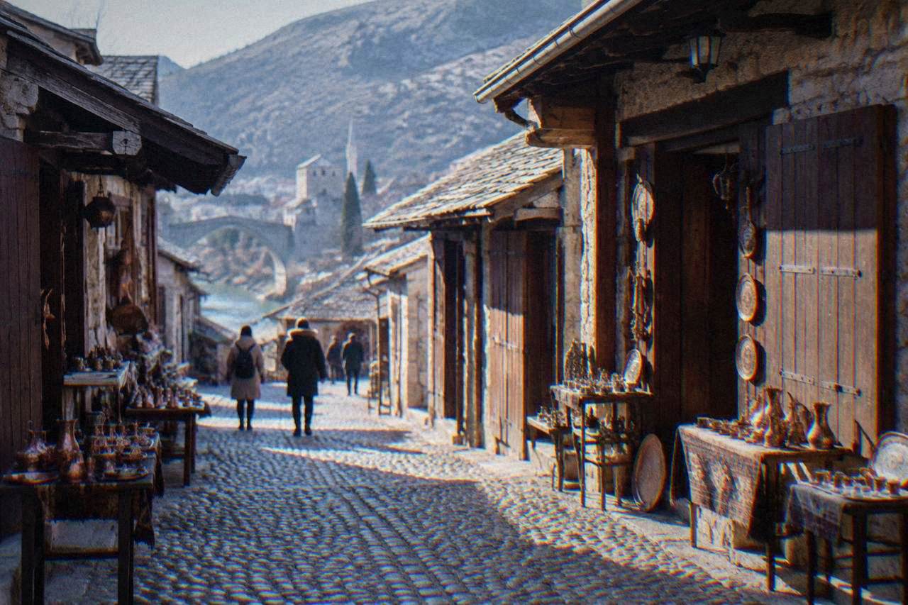 Shop signs along a stone street in the old bazaar in Mostar