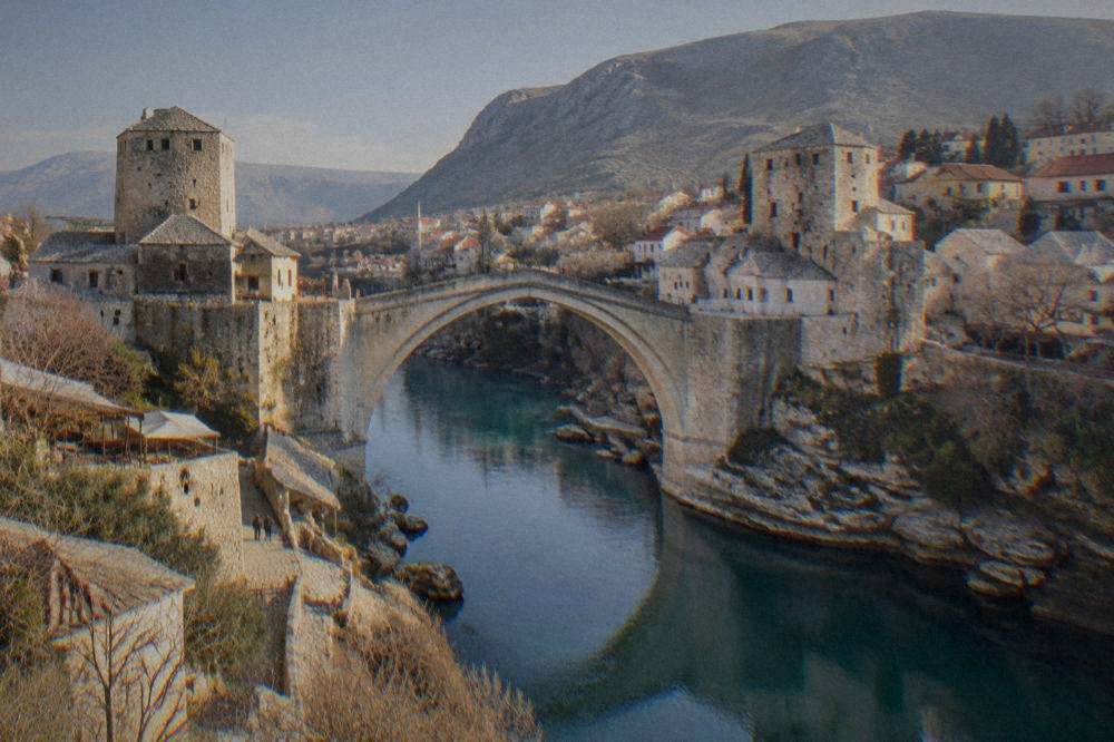 Golden evening light on the Old Bridge and river from the east bank in warm weather