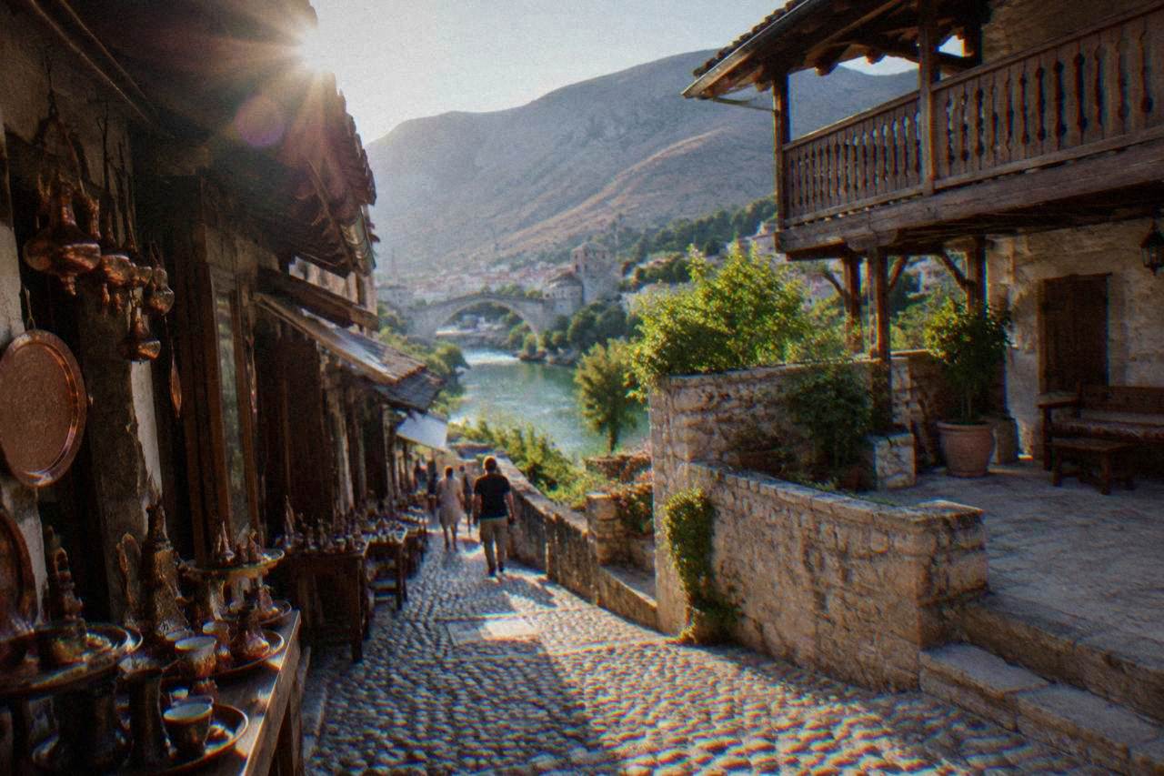 Stone courtyard of an Ottoman house in Mostar with a wooden balcony above the Neretva