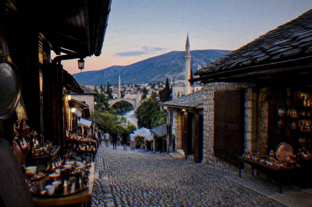 Evening light over the rooftops and minarets of central Mostar near the park