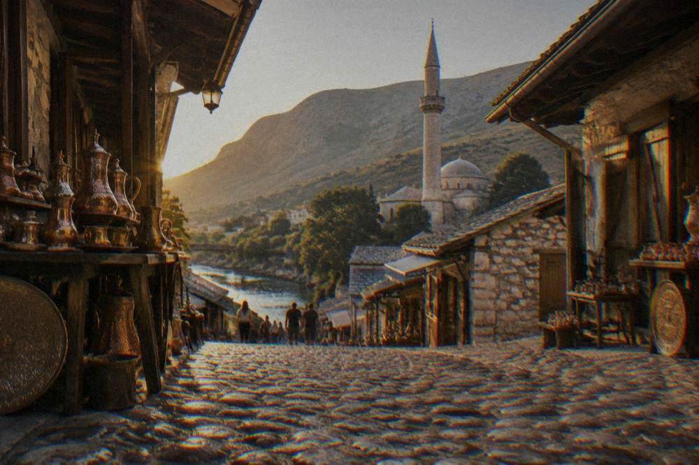 A stone mosque minaret rising above old roofs near a river in Mostar