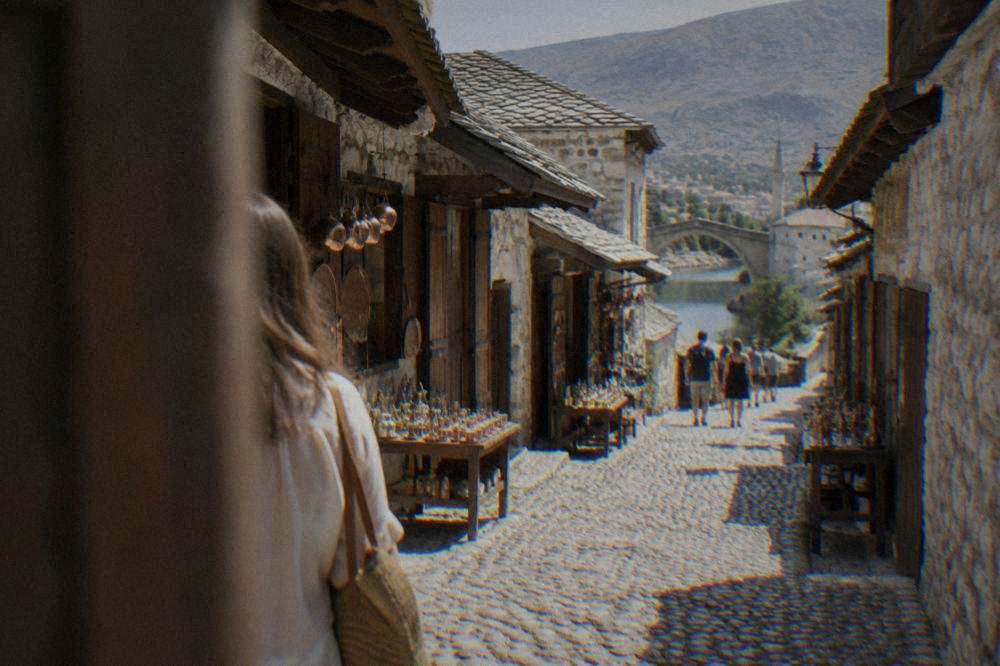 Cobbled lane of river stone winding between old houses in Mostar