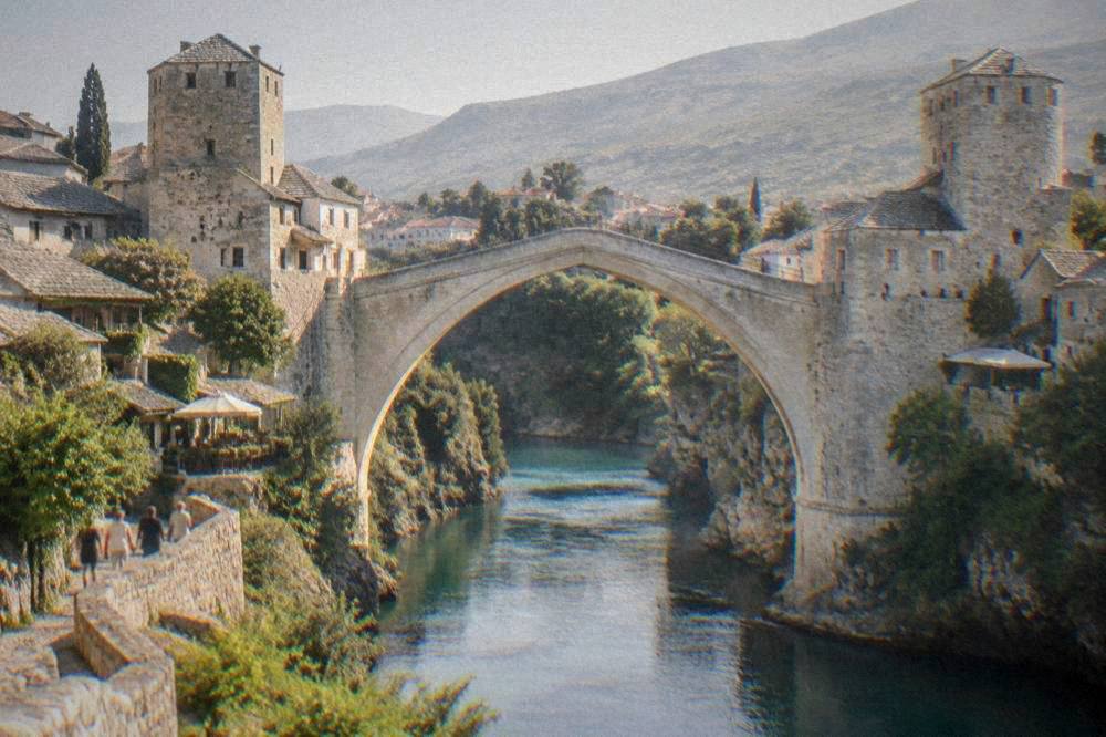 Evening light on the single stone arch of Stari Most above the green Neretva river
