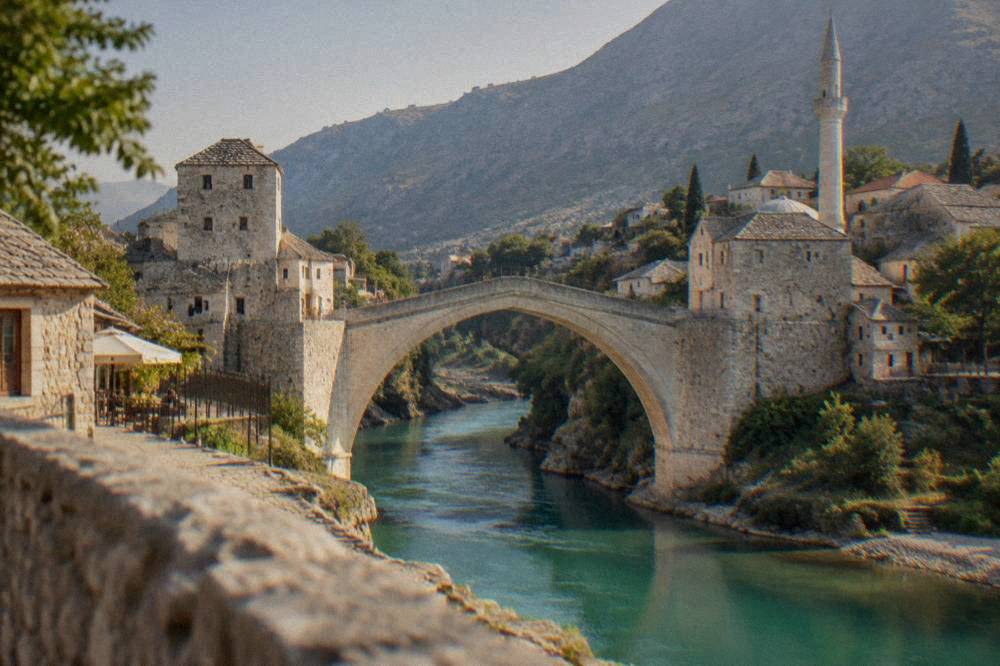 Mosque minaret terrace overlooking the turquoise Neretva river and Stari Most