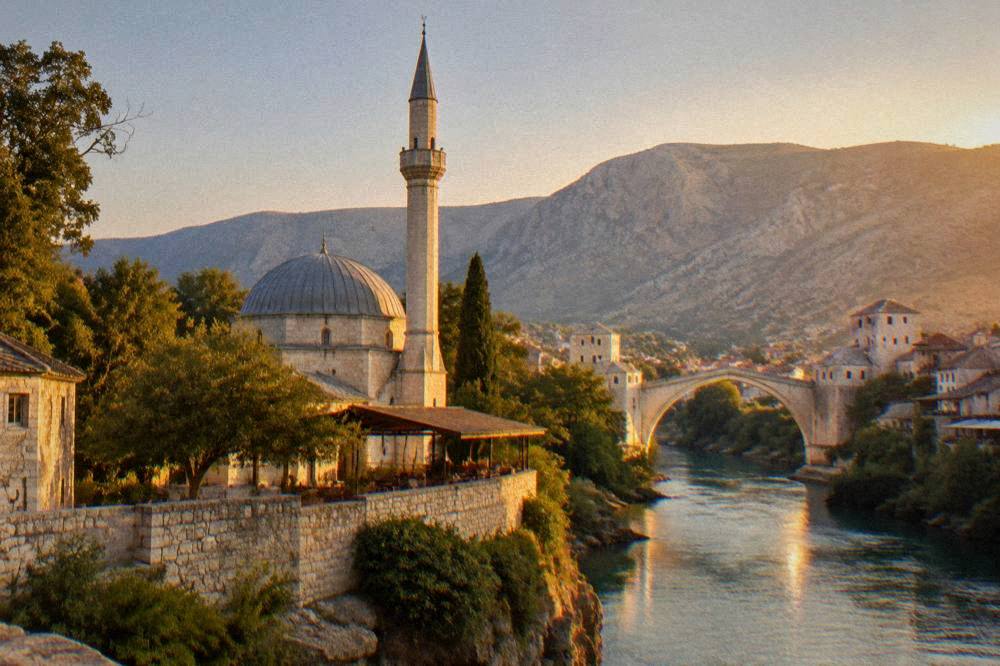 Sunset light on a stone minaret with a single-arch bridge glowing over a river in the background