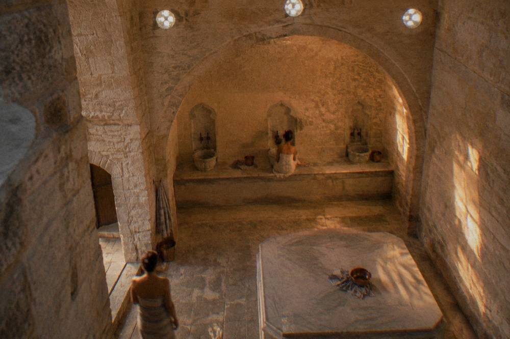 Interior stone washing alcove of a restored Ottoman bathhouse with arched niche