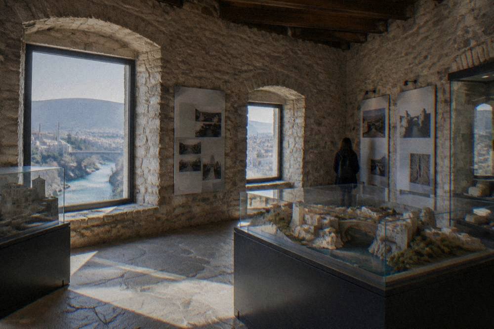 The interior of a stone tower room with display panels and models