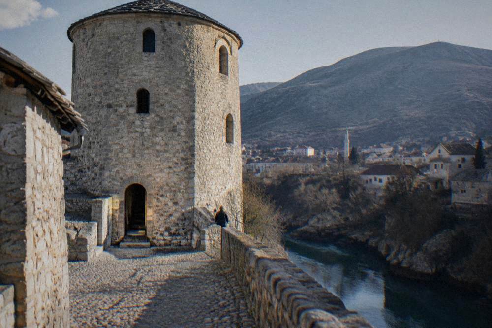 A stone stairway inside a circular tower with arched windows