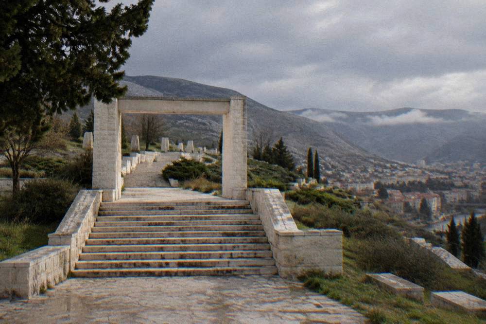 A wide stone staircase and gateway leading up into a memorial enclosure