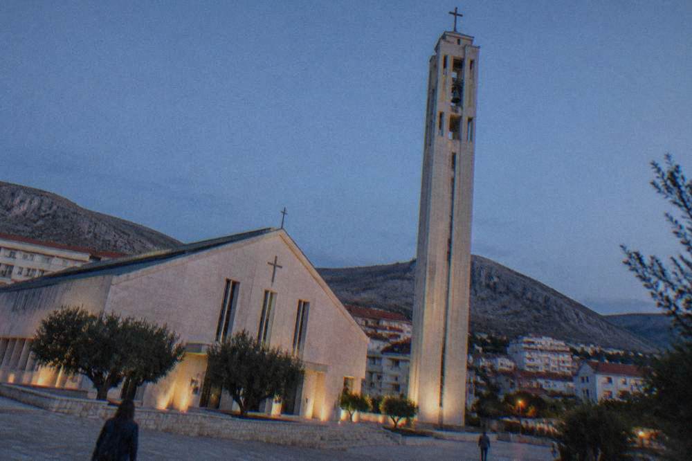 Looking up at the bell tower shaft from the church square below