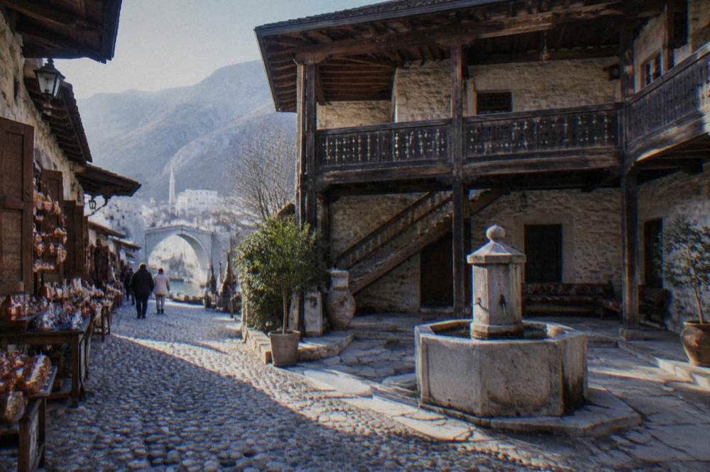 The courtyard of an Ottoman stone house in Mostar with a fountain and wooden gallery