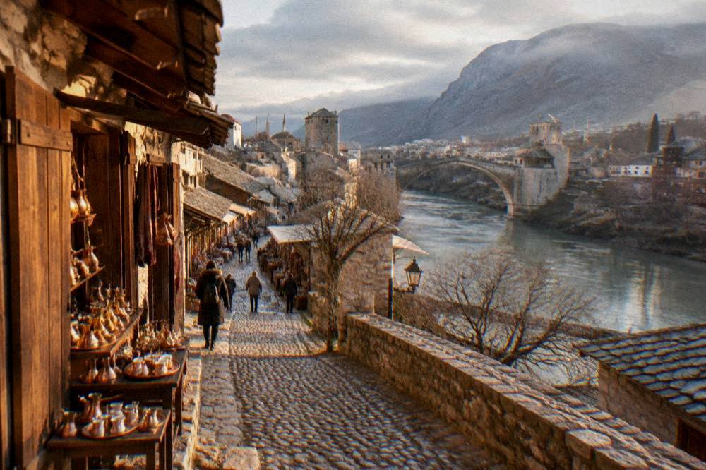 An empty city square in Mostar under low winter clouds with wet paving stones
