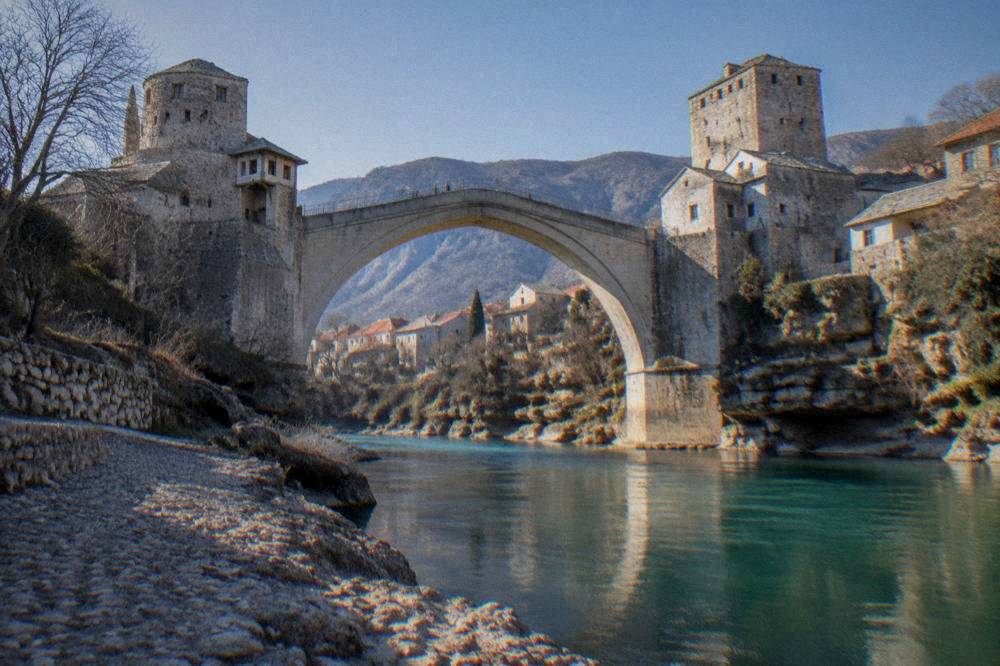 The emerald Neretva river flowing under the Old Bridge in Mostar