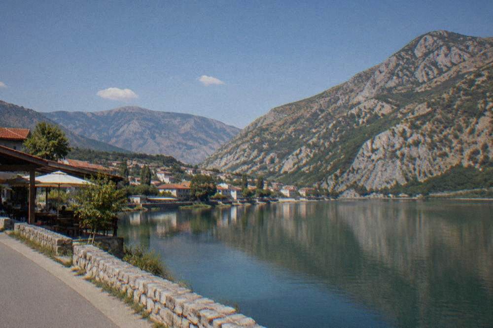 The calm surface of Jablanica lake framed by dry hills above the town