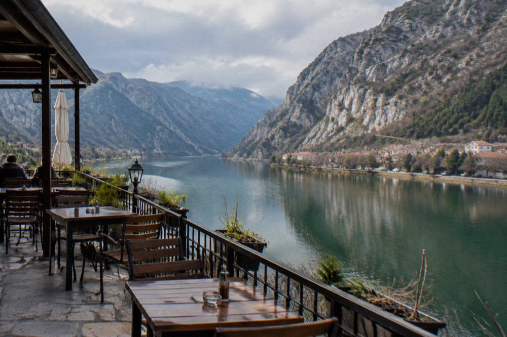 A riverside restaurant terrace above the Neretva with the canyon in the background