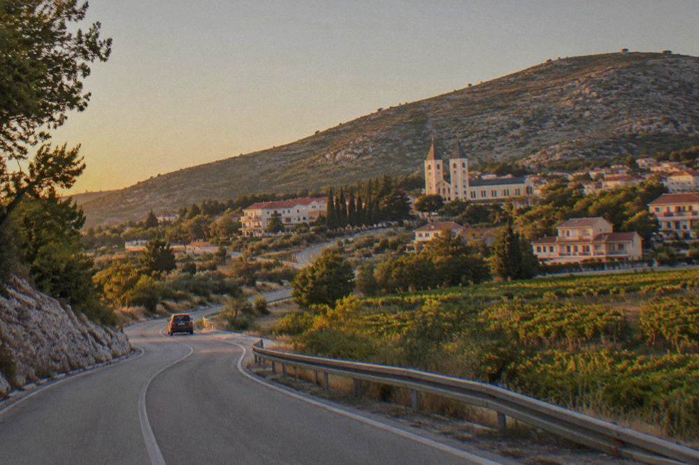 A country road winding through Herzegovina hills between Mostar and Međugorje