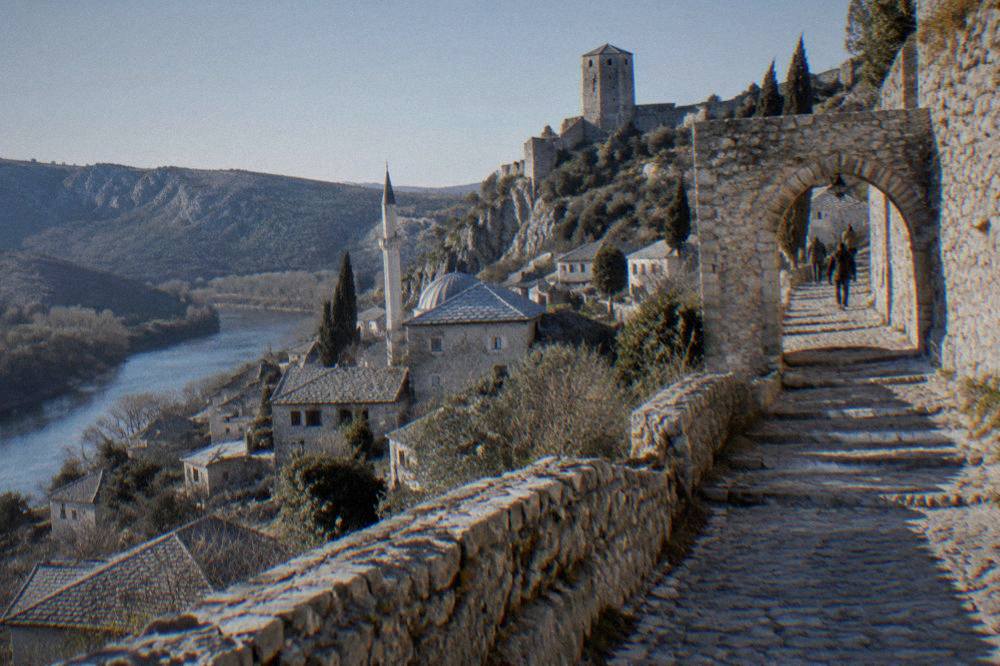 Ancient stone walls and an archway on the path to the fortress in Počitelj