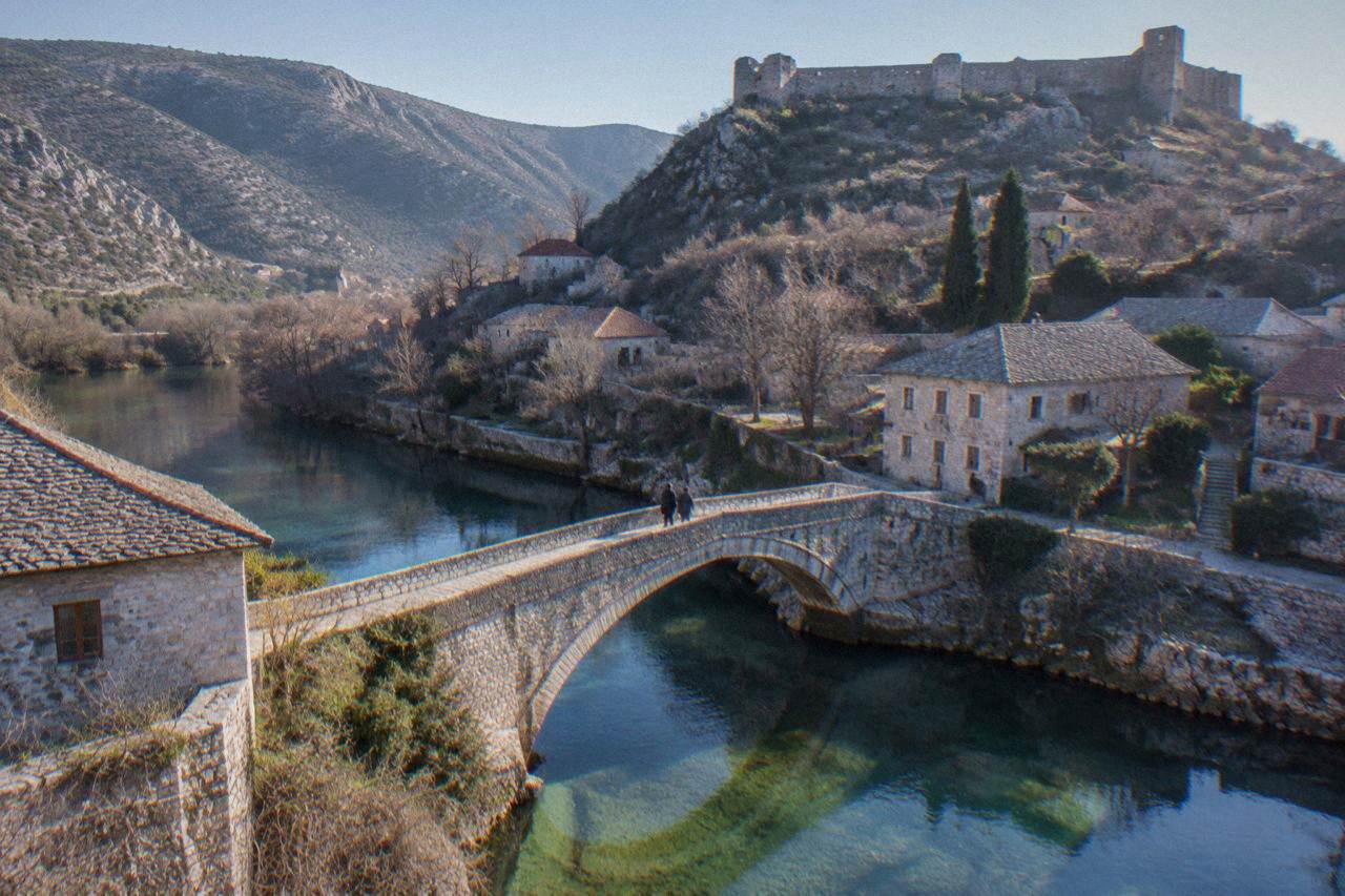 Stone bridge and old houses along the Bregava river in Stolac