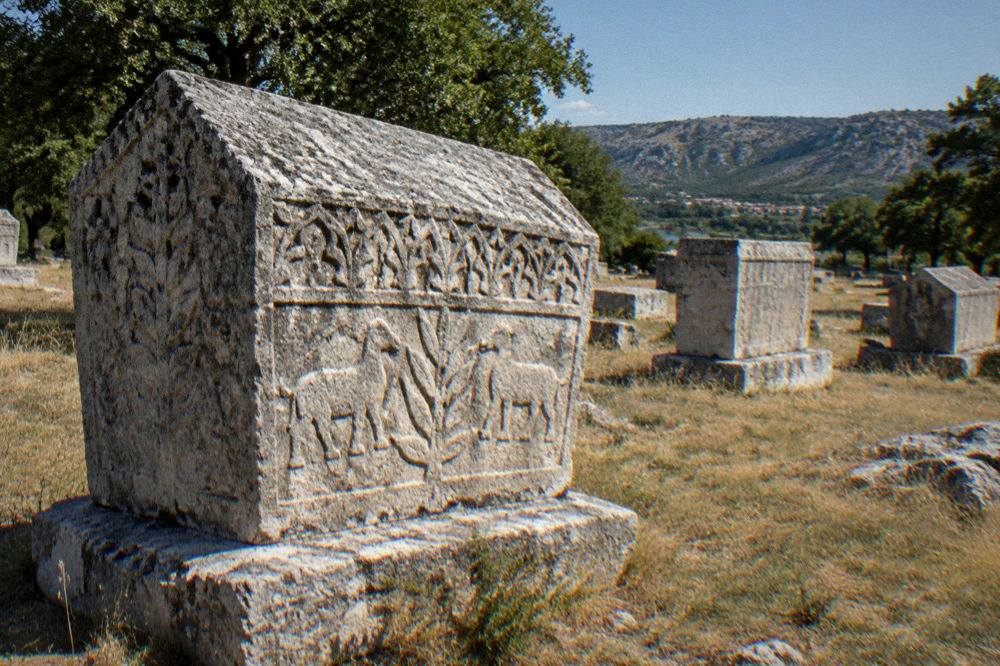 Sunlit carved decoration on a medieval stećci stone at Radimlja
