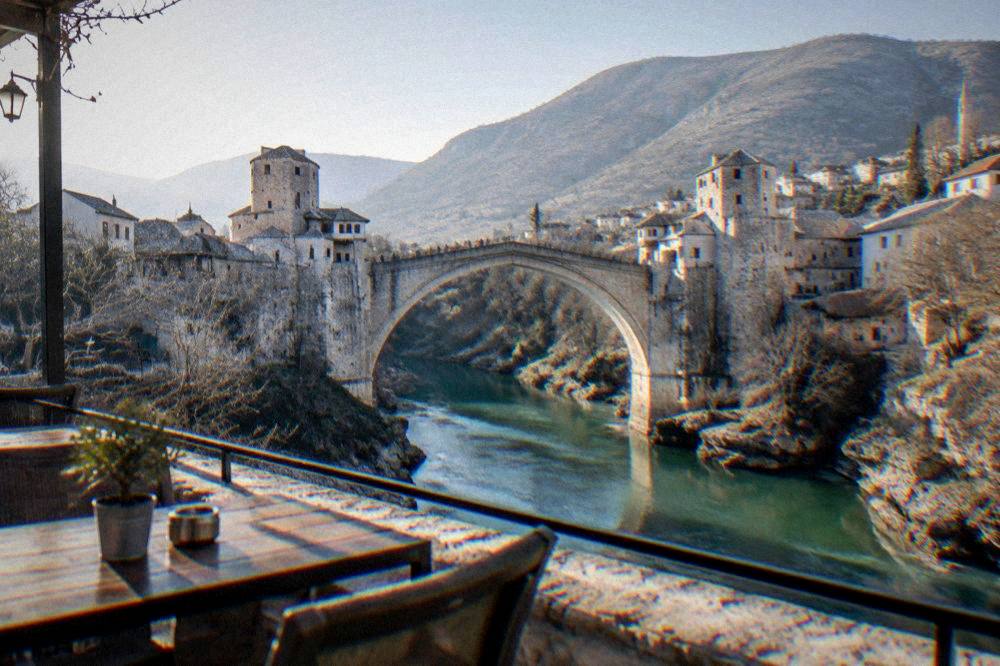 A terrace table overlooking the Neretva with the Old Bridge in the middle distance