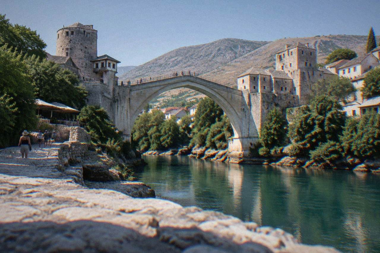 The Old Bridge in Mostar under a clear summer sky above the Neretva river