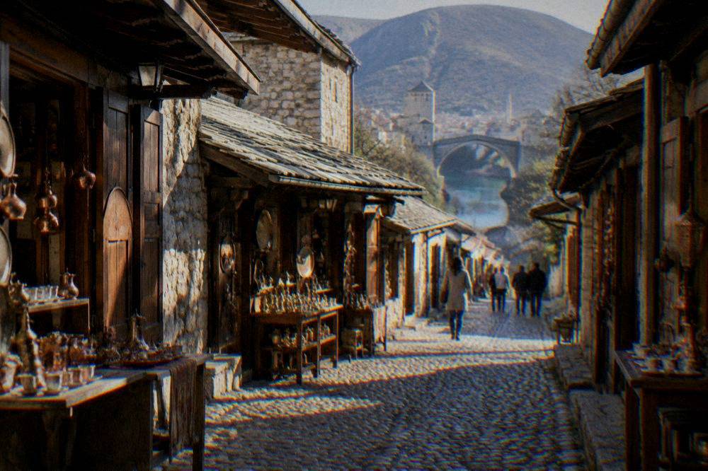 A cobbled bazaar street in Kujundžiluk lined with small shops under overhanging roofs