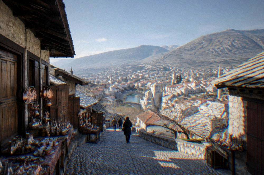 A view over the red rooftops of central Mostar with hills rising behind the city