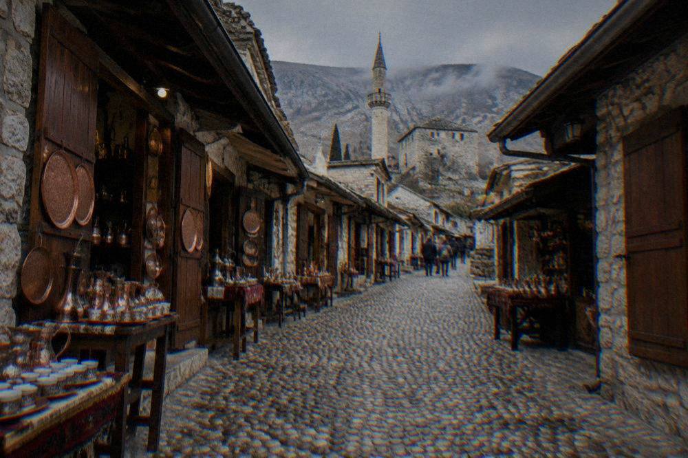 Cobbled street of the Kujundžiluk bazaar with copper shops and stone buildings