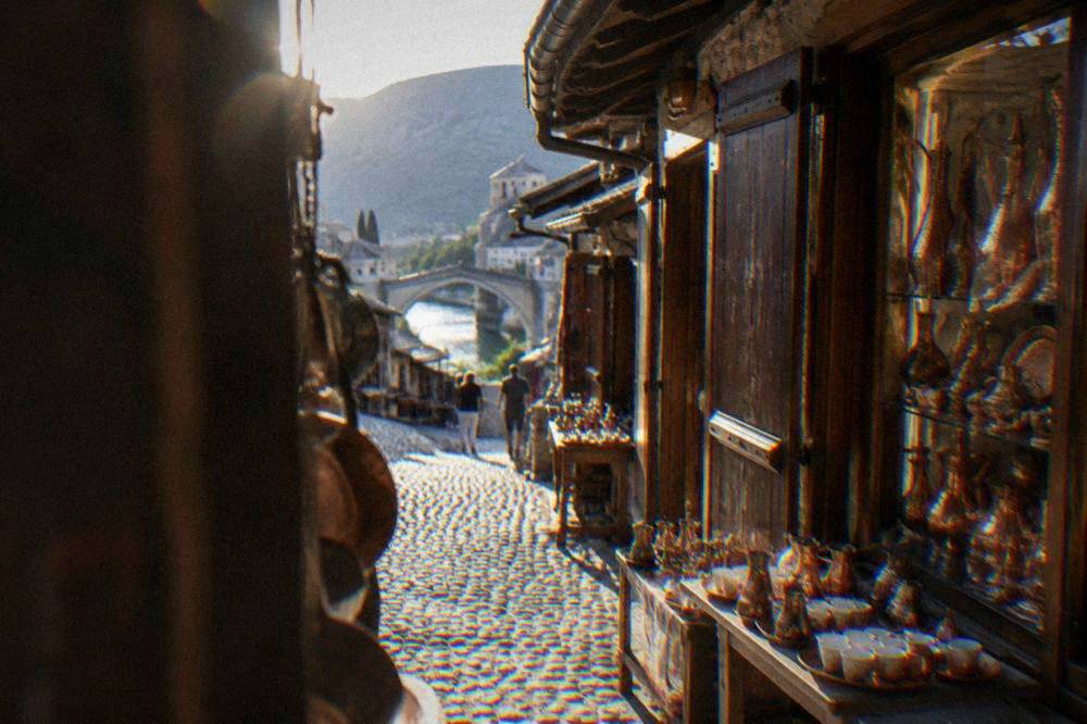 Copper goods and souvenirs displayed in a bazaar shop window in Mostar