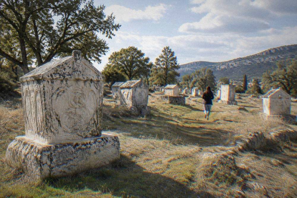 Rows of carved medieval stone tombstones on open ground at Radimlja near Stolac