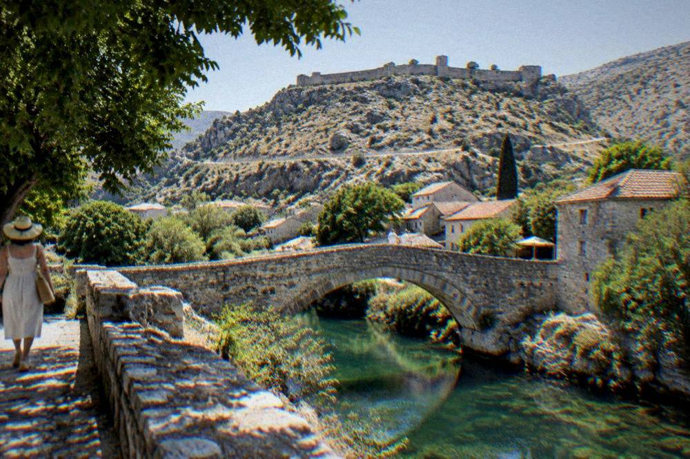 Dry limestone hills with a winding road under a clear summer sky in Herzegovina