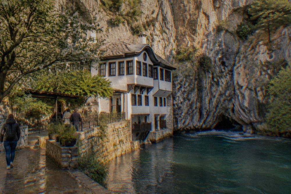 The white walls of the Blagaj Tekke built into the cliff beside the Buna spring