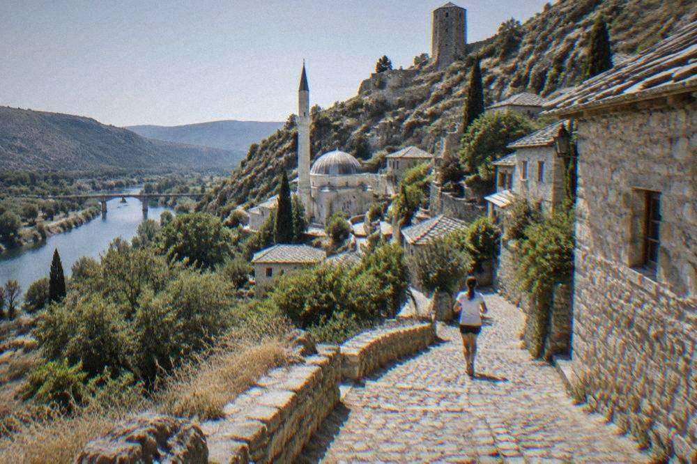 Stone houses and a minaret climbing the hillside of Počitelj above the Neretva valley