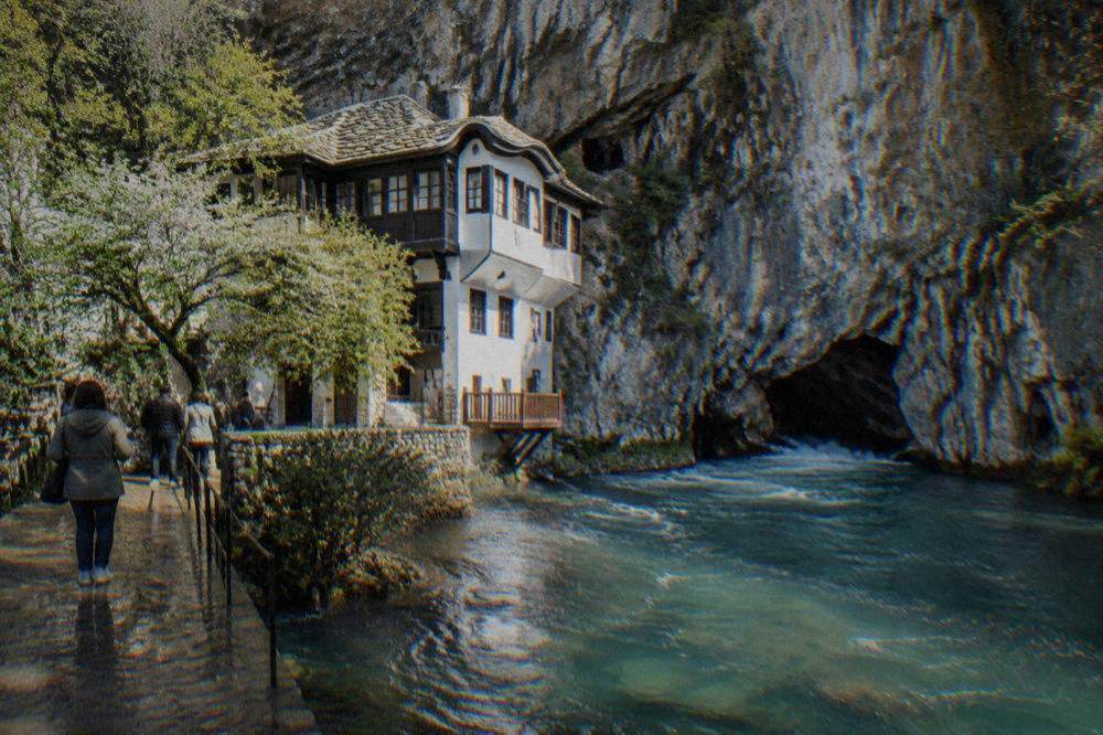 Turquoise water of the Buna spring flowing beneath cliffs at Blagaj