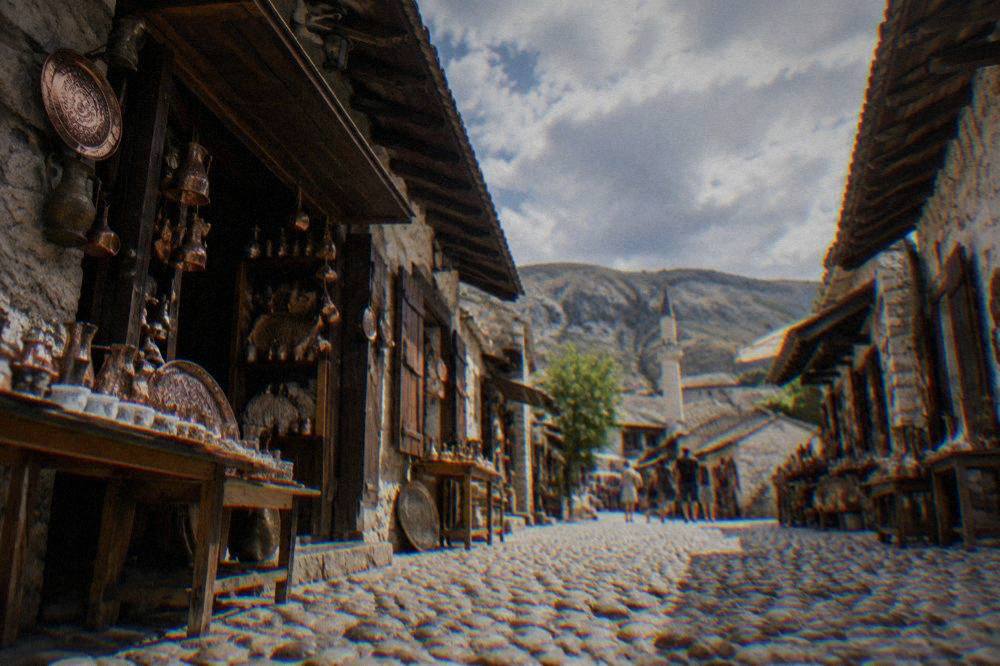 Cobblestone street of the Kujundžiluk bazaar lined with small shops and copper goods