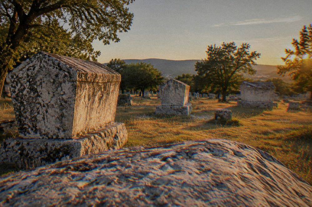 Medieval stećci tombstones in a field at the Radimlja necropolis near Stolac