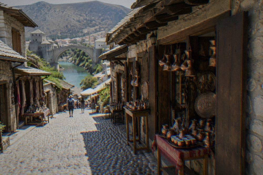A cobbled bazaar lane in Kujundžiluk lined with small shops under stone eaves