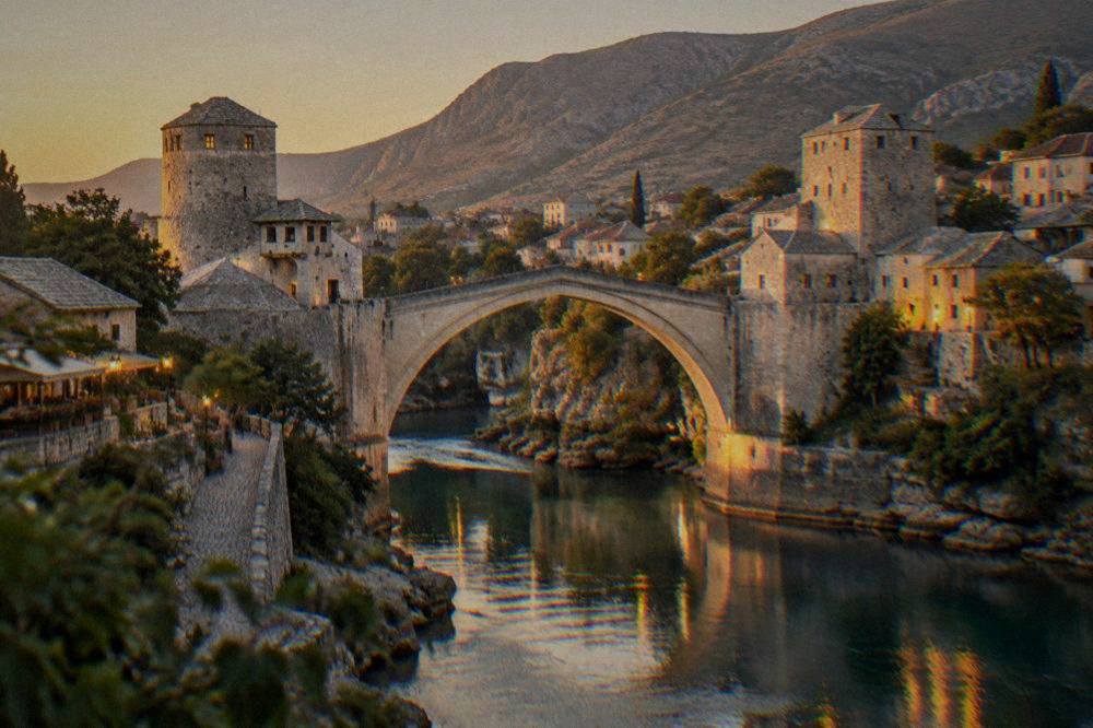 Evening lights reflecting in the Neretva river below the Old Bridge in Mostar