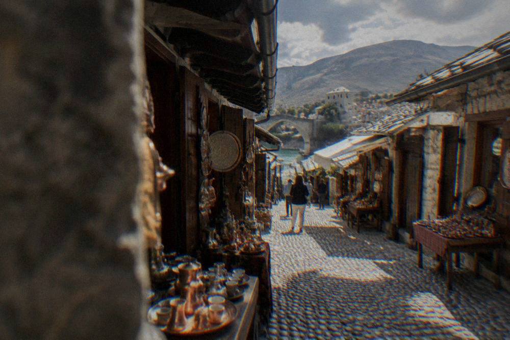 A narrow cobbled bazaar lane lined with small shops selling copperware and souvenirs